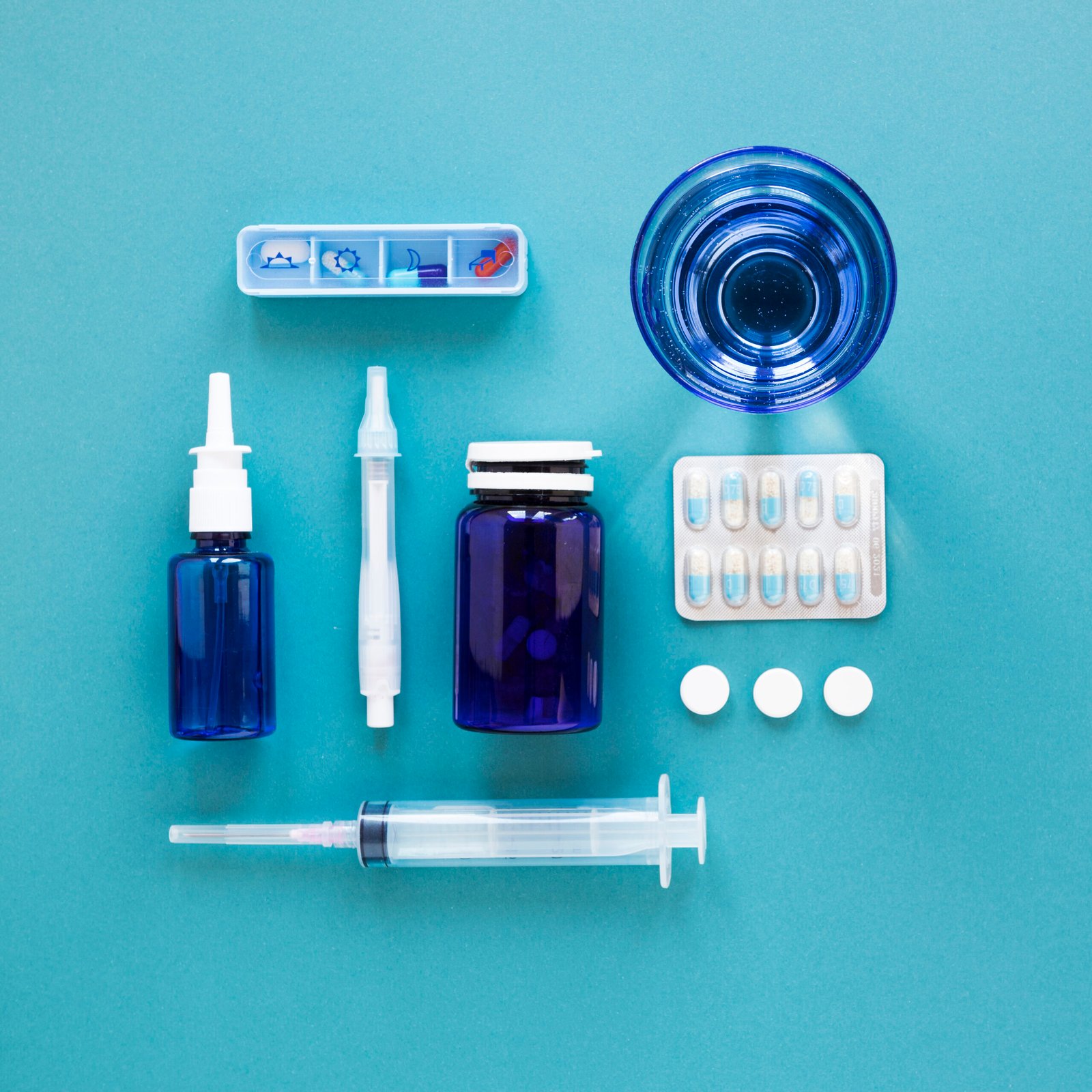 top view glass water with pills needle